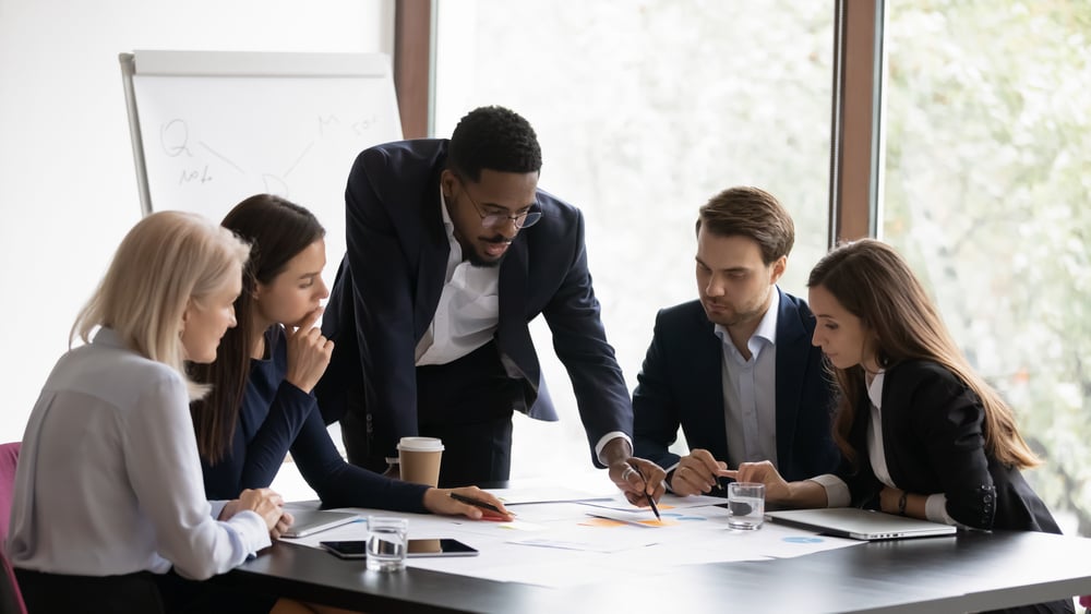 Confident Business Leader Showing Team Information